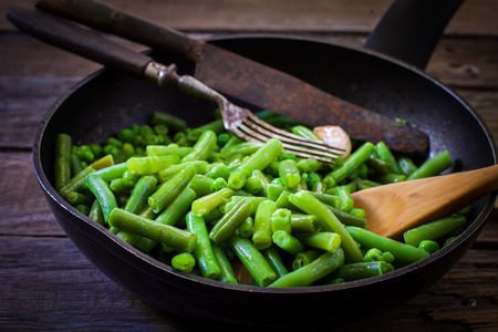cooking fresh green beans on frying panの写真素材