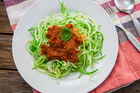 vegetarian pasta made with zucchini spaghetti and tomato pestoの写真素材