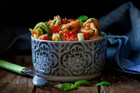 fresh pasta salad with mint on decorated blue bowlの写真素材