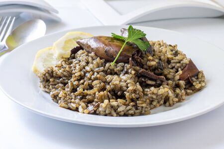 homemade rice with squid on ink sauce