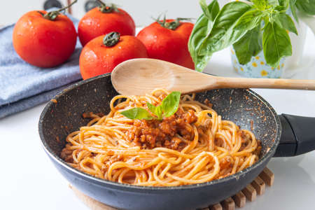 homemade bolognese spaghetti on pan with herbsの写真素材