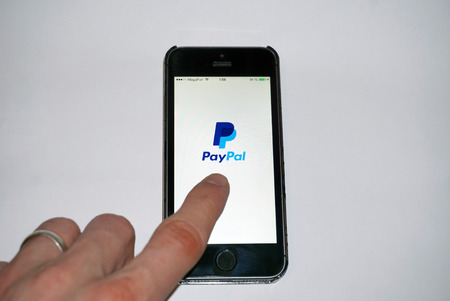 Samara, Russia - February 15, 2015: PayPal app open in the mobile phone Iphone 5s. Apple Corporation main direction rapidly developing market of smartphones. PayPal free application in app storeのeditorial素材