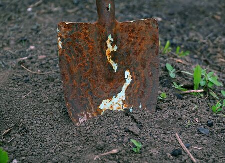 Old rusty shovel in the groundの写真素材
