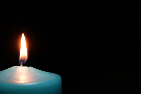 burning candle isolated on black. religious symbolの写真素材