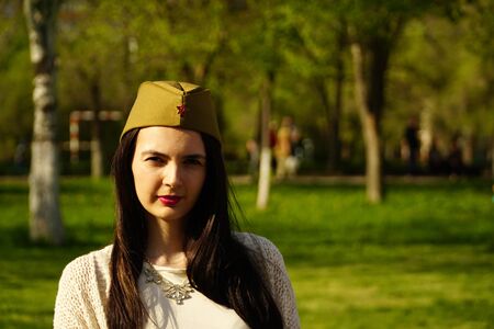 a woman wears Soviet military hat outdoors.の写真素材