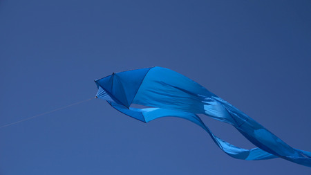 A kite flies in the sky close up.の写真素材