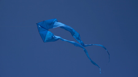 A kite flies in the sky close up.の写真素材