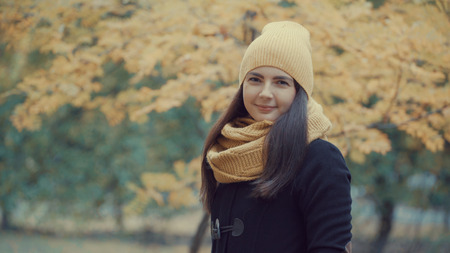 portrait of a beautiful girl in a park in autumnの写真素材