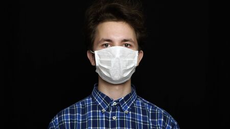 Boy feeling sick and wearing mask.の写真素材