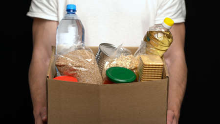 Volunteer putting food in a donation box