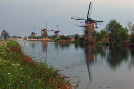 Dutch windmills with canal reflections at Kinderdijk, Netherlandsの写真素材