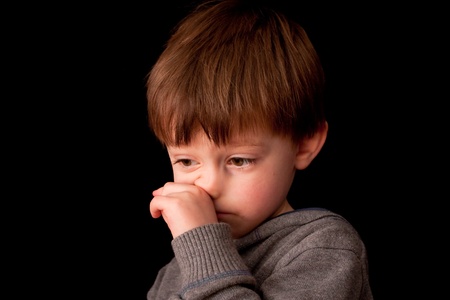 cute little boy wiping his nose