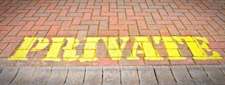 Pivate written in yellow paint on brickworkの写真素材