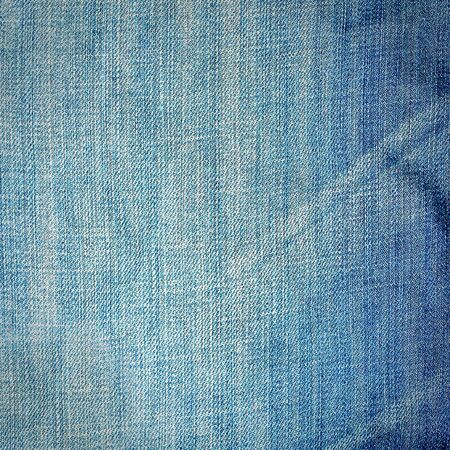 Striking background image of denim material with creasesの写真素材