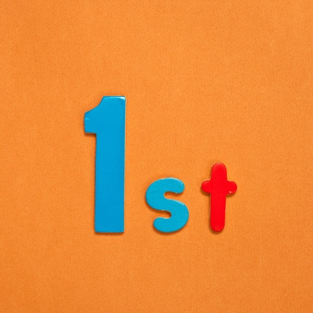 1st in colorful toy figures on a vibrant orange background, plenty of crop room