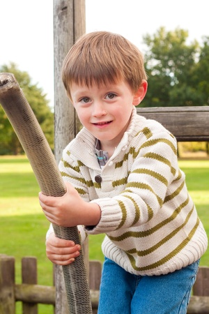 Little boy playing on a zip wire in a parkの写真素材