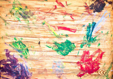 Dabs of paint on a wooden artist's boardの写真素材