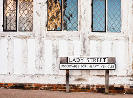 Street name and a road sign outside an old building in Lavenham, Suffolk, UKの写真素材