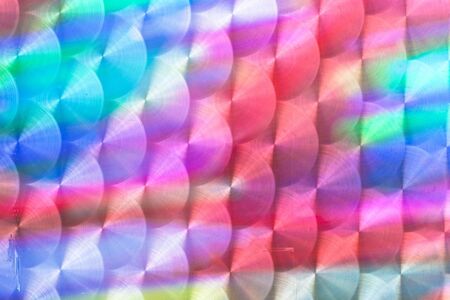 Colorful light reflected in a textured metal surfaceの写真素材