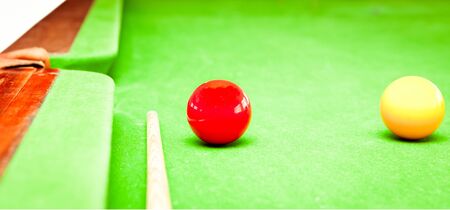 Close up of two balls and a cue on a traditional billard tableの写真素材