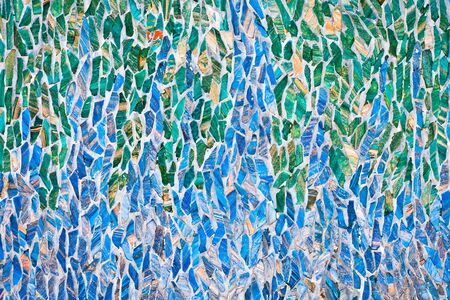 Haphazard blue and green mosaic pattern on a wallの写真素材