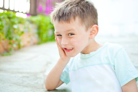 A happy four year old boy in a gardenの写真素材
