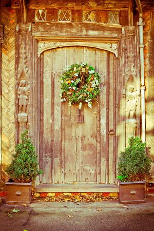 A decorative traditional christmas wreath on an old doorの写真素材