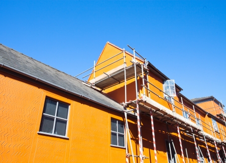 Scaffolding on an orange town building in Suffolk, UKのeditorial素材