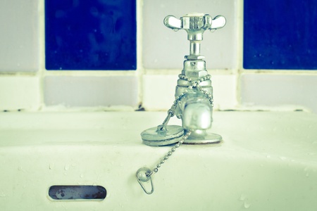 Still life image of a bathroom tap in cold tones