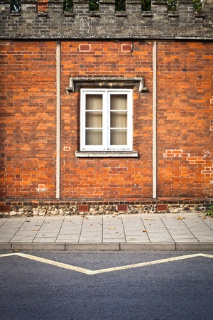 A window in a red brick wall in an english buildingの写真素材
