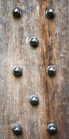 Close up of wood panel studded with boltsの写真素材
