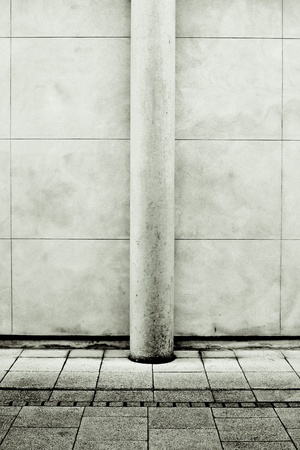 Modern stone pillar against a wall in monochromeの写真素材