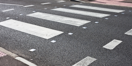 Details of a pedestrain crossing on a tarmac roadの写真素材