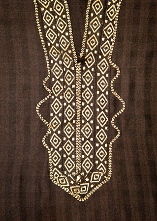 Close up of embroidered neck line on a black moroccan men's robeの写真素材