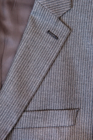 Close up of the collar and breast pocket of a pin stripe suitの写真素材