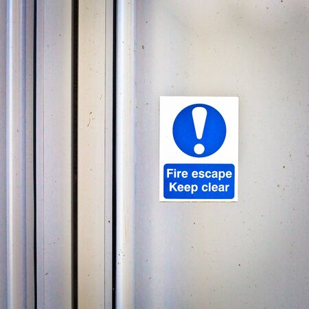 Fire escape sign on a modern door panelの写真素材