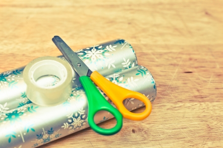 Scissors, tape and wrapping paper on a wooden tableの写真素材