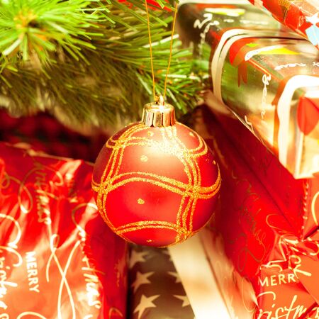 close up of christmas tree decorations and wrapped presentsの写真素材