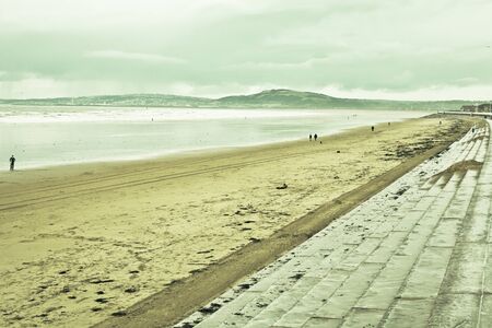View of aberafan beach in South Wales in winter, with Swansea city on the distanceの写真素材