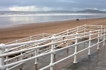 view of aberafan beach in South Wales in winter, with Swansea city in the distanceの写真素材