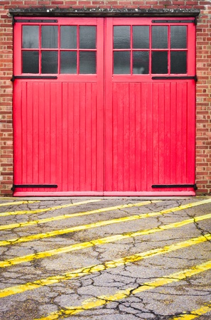 Red fire station door with yellow linesの写真素材