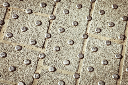 Metallic studs in concrete at a pedestrian crossingの写真素材