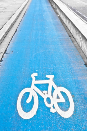 Blue designated cycle path in a cityの写真素材