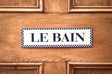 Bathroom sign in French on a wooden doorの写真素材