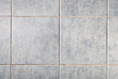 Close up of grey square tiles as a backgroundの写真素材