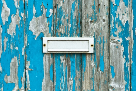 Letter box in a weathered wooden doorの写真素材