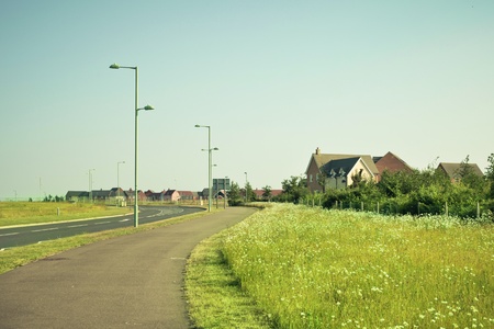 Cycle path adjacent to a modern housing estate in rural Englandの写真素材