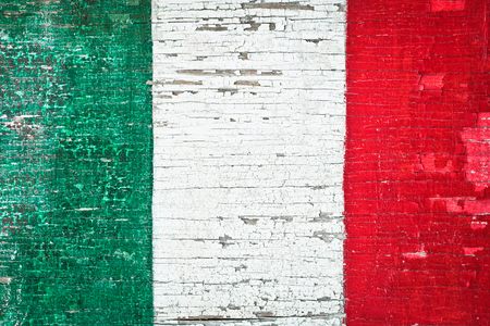 Colors of the Italian flag painted on a weathered wood backgroundの写真素材