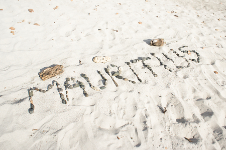Mauritius written in pebbles on a sandy beachの写真素材