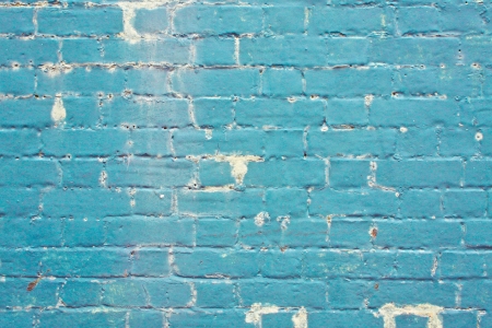 A weathered grungy blue brick wall as a backgroundの写真素材